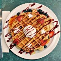 Belgian Waffle · Thick Belgian waffle topped with fresh fruit and whipped cream.