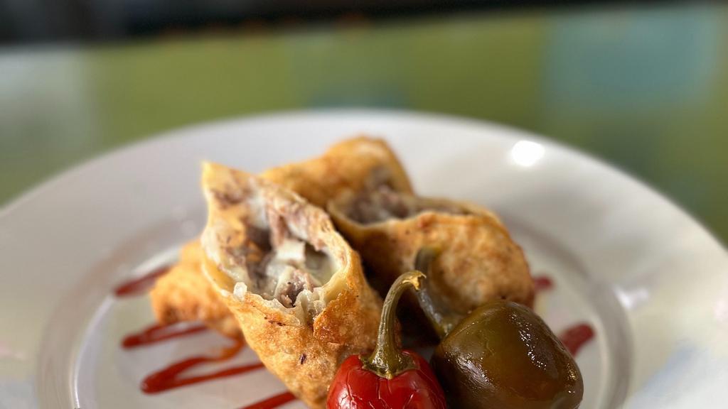 Cheesesteak Egg Rolls · Sliced steak, onions, American cheese in an egg roll wrapper, served with spicy ketchup and a whole cherry pepper