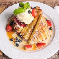 Creme Brûlée French Toast · Sliced challah bread, dipped in vanilla bean custard topped with berry compote, vanilla angl...