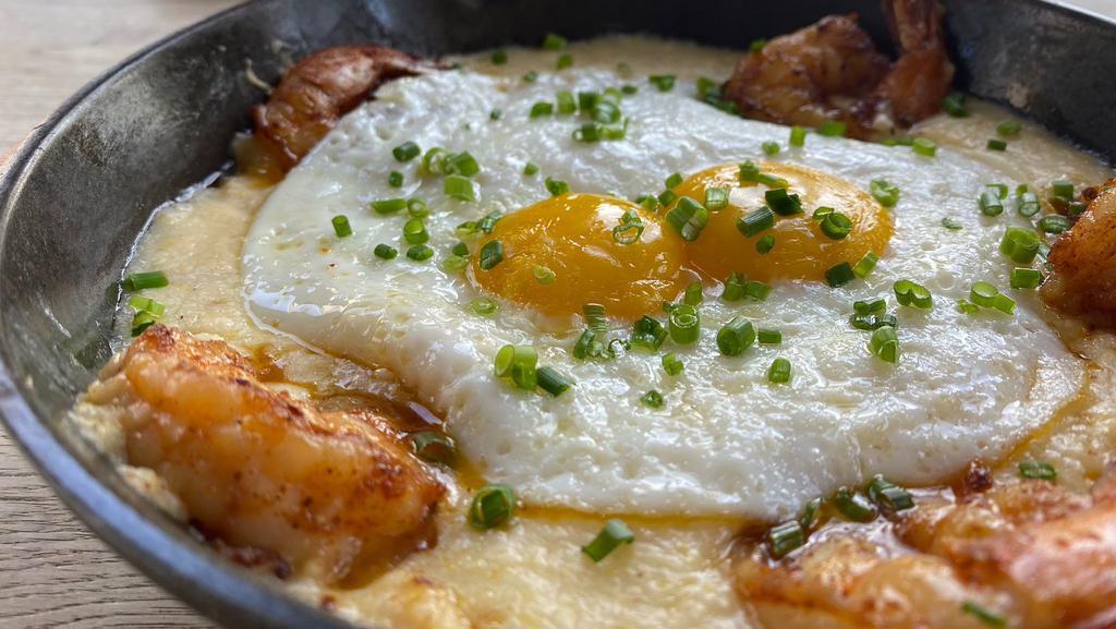 Creole Shrimp & Grits · Seared gulf shrimp cooked in a spicy creole sauce, served on top of stone ground cheesy grits, topped with two eggs your way, served with a side of creole sauce.