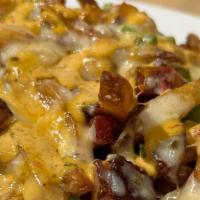 Baja Hot Fries  · house cut French fries tossed with jalapeños, bacon lardons and Tex-Mex  cheese smothered in...