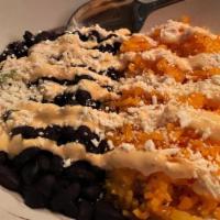 Rice & Beans · Annato scneted jasmine rice, black beans cooked with mexican herbs and spices.