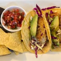 Crispy Fish Tacos · Panko crusted cod, fresh avocado, shaved cabbage, salsa Verde, and blue and white corn torti...