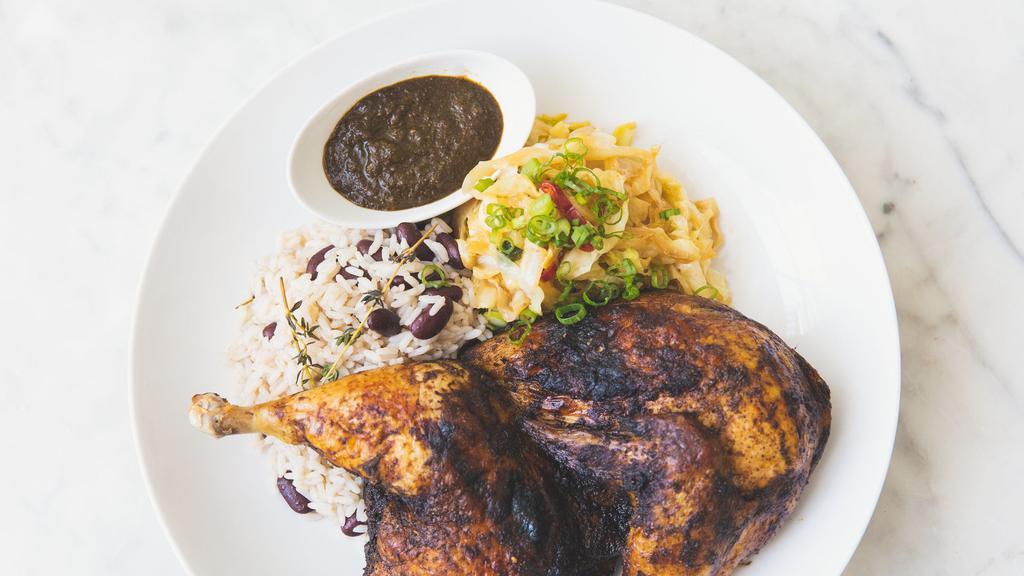 1/2 Jerk Chicken · rice and peas, and stewed cabbage.