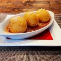 Arancini · (3) Fried risotto balls stuffed with mozzarella & pecorino, served with marinara sauce.