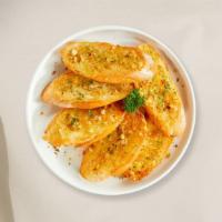 Garlic Bread · Housemade bread toasted and garnished with butter, garlic, and parsley.