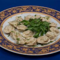 Chicken Ravioli · Small chicken dumplings garnished with a drizzle of butter.