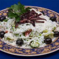 Greek · Romaine lettuce, tomatoes, cucumbers, onions, air-dried cured meat, feta, and black olives w...