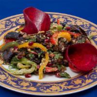 Eggplant Salad · Baked eggplant with sweet peppers and onions garnished with walnuts and pomegranate.