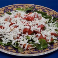 Molodejniy Salad · Mixed spring greens, tomatoes, and feta with a garlic dressing.