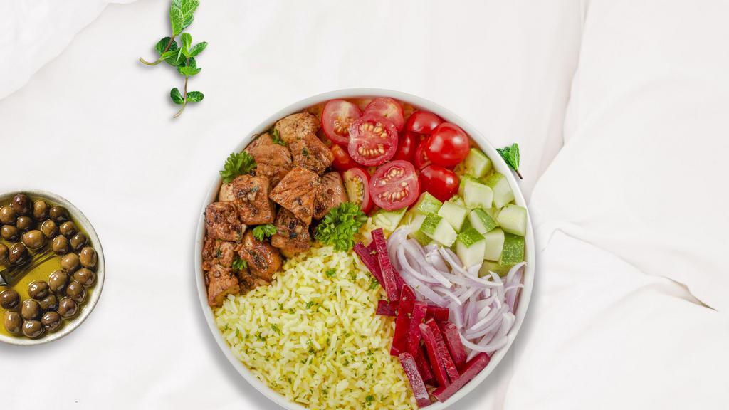 Chatty Chicken Rice Bowl · Skewered pieces of chicken breast marinated in a mediterranean blend of herbs and spices served with yellow rice and mixed vegetables.