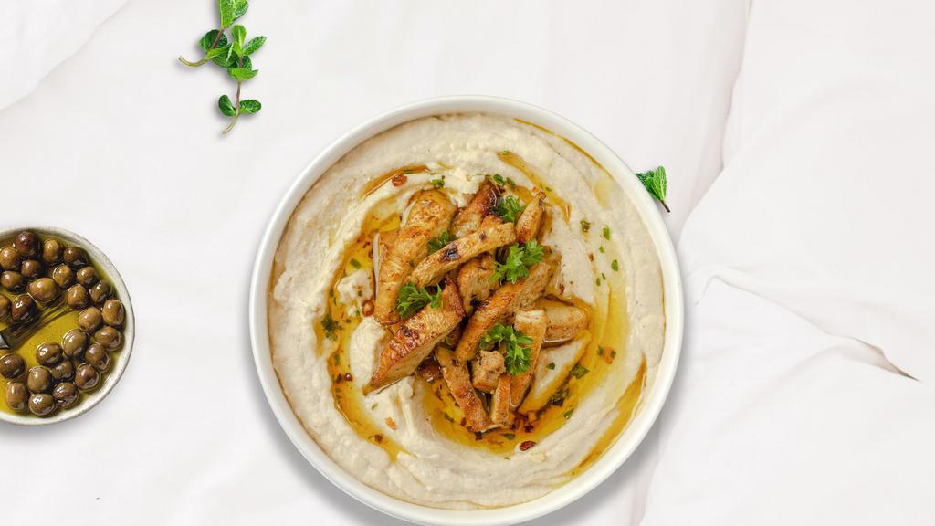 Cheeky Chicken Shawarma Bowl · Stir fried shredded chicken breasts marinated in a mediterranean blend of herbs and spices served on a bed of authentic hummus