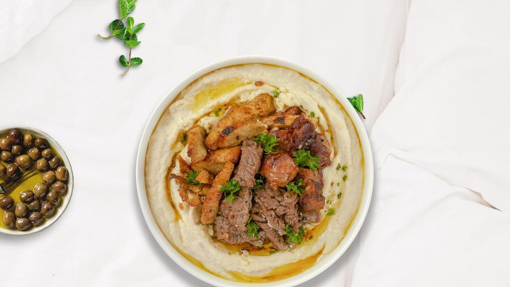 Mighty Meat Combo Hummus Bowl · Skewered pieces of chicken, lamb, beef marinated in a mediterranean blend of herbs and spices served on a bed of authentic hummus