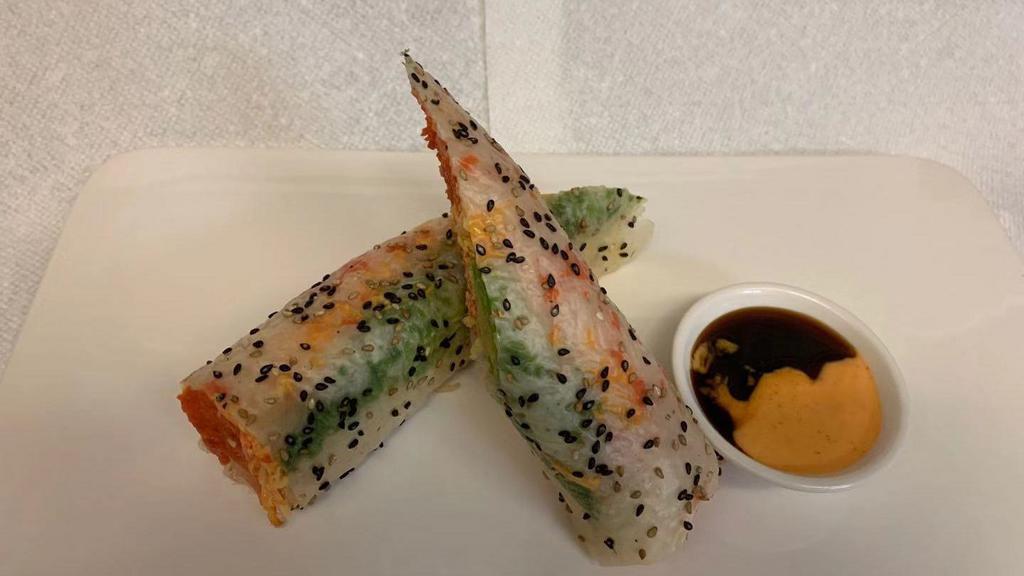 Sushi Burrito · Salmon avocado, spicy kani shrimp, spicy tuna crunch wrap with sesame soy paper.