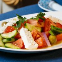 Classic Greek Salad · Vine-ripened tomatoes, cucumbers, olives, green peppers, red onions and feta with red wine v...