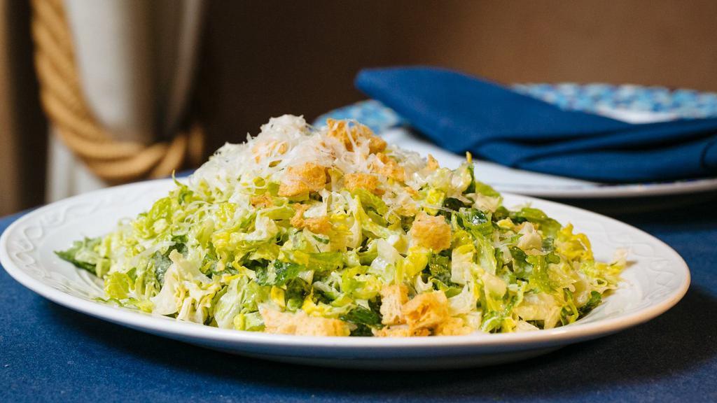 Romaine Salad · Vegetarian. Chopped romaine hearts, house-made oregano croutons, grated feta and kefalograviera cheeses.