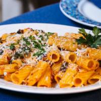 Pasta Ala Grecca (Entree) · Rigatoni sautéed with roasted tomato sauce and spinach topped with grated feta.