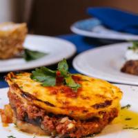 Moussaka (Entree) · Traditional layered casserole with ground beef, potatoes, sliced eggplant, and kefalogravier...