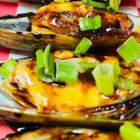 Baked Mussels · Baked mussels with tobiko, green onion, eel-lava sauce, sriracha.