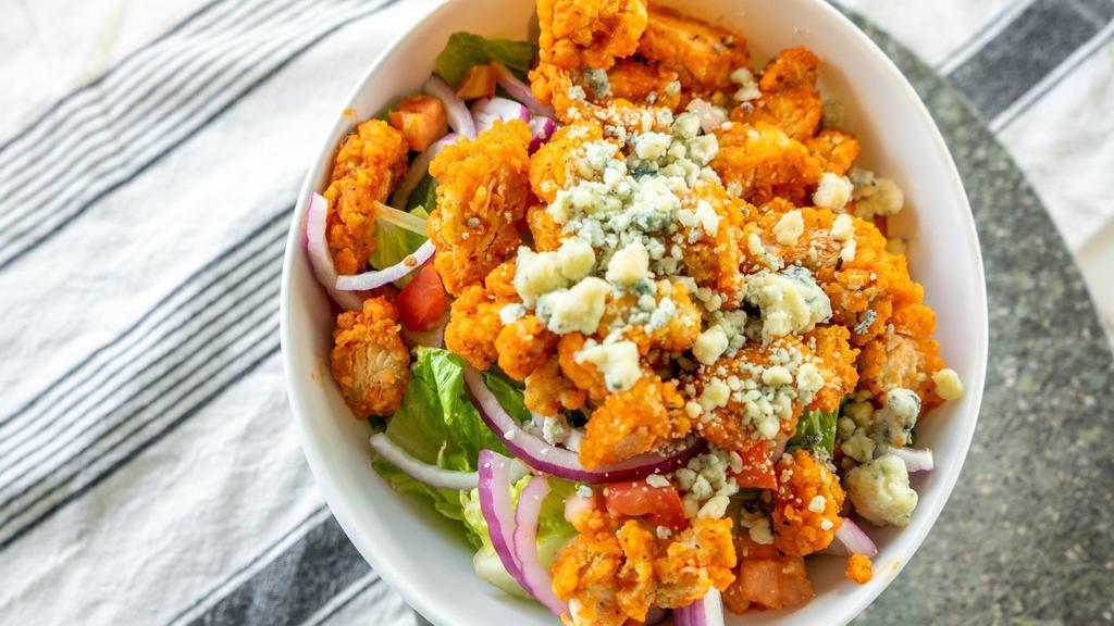 Buffalo Chicken · Romaine lettuce topped with buffalo crispy chicken, diced celery, red onions, bleu cheese crumbles, and fresh tomatoes served with a side of buffalo ranch.