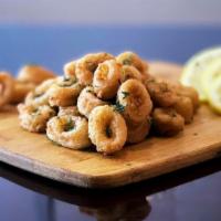 Fried Calamari With 2 Sides · Coated in seasoned flour and deep fried to golden brown perfection, comes with marinara sauc...