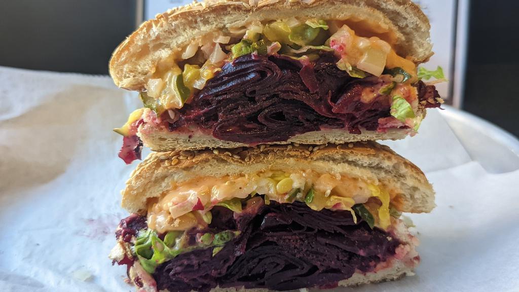 Beet Mac · House pastrami spiced beets, secret sauce, pickles, diced onions, vegan cheese, toasted seeded bun. (VEGAN)