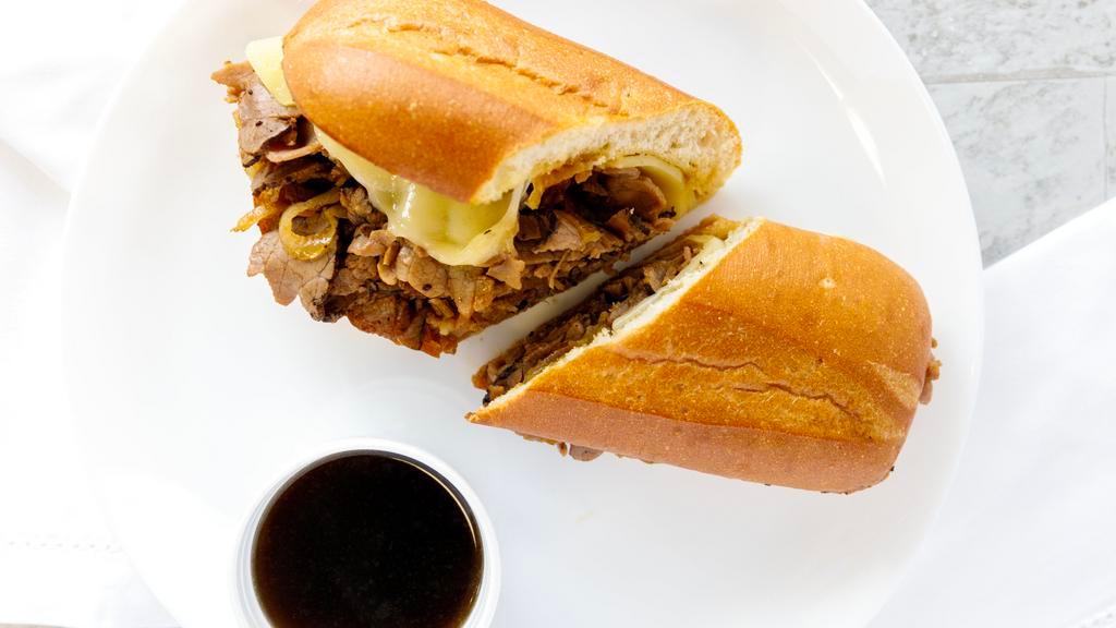 French Dip · Thin sliced roast beef grilled with sautéed onions topped with swiss cheese on a toasted hoagie bun served with a side of aujus