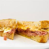 Reuben Sandwich · Thin sliced corn beef grilled and stacked on thick, grilled rye bread with melted swiss chee...