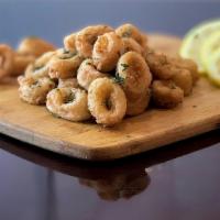 Fried Calamari · Lightly breaded calamari, tender in the inside and crispy fried to golden brown perfection.