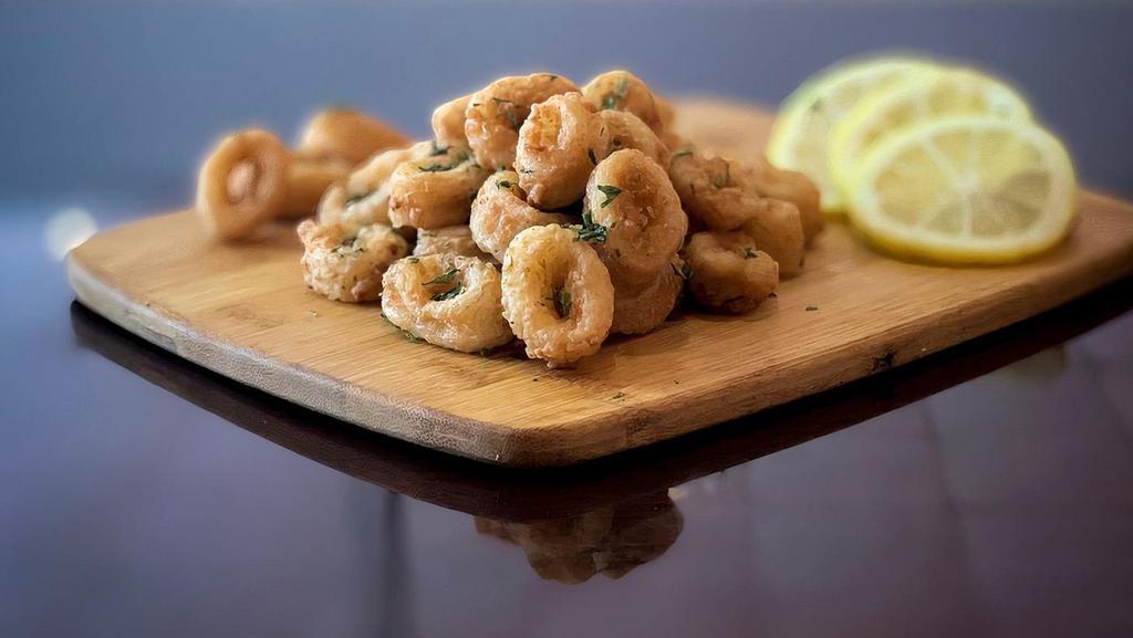 Fried Calamari · Lightly breaded calamari, tender in the inside and crispy fried to golden brown perfection.