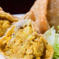 Vegetable Samosa · Crispy turnovers with seasoned potatoes and green peas. Served with versatile Indian homemad...