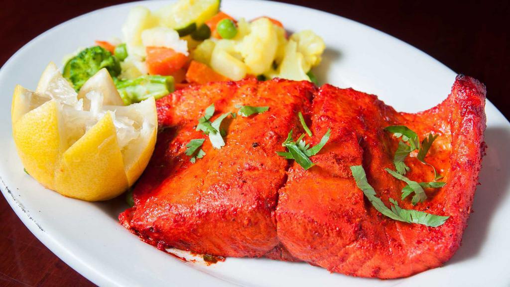 Salmon Tikka (Appetizer Size) · Marinated chunks of salmon skewered and roasted in a tandoor oven