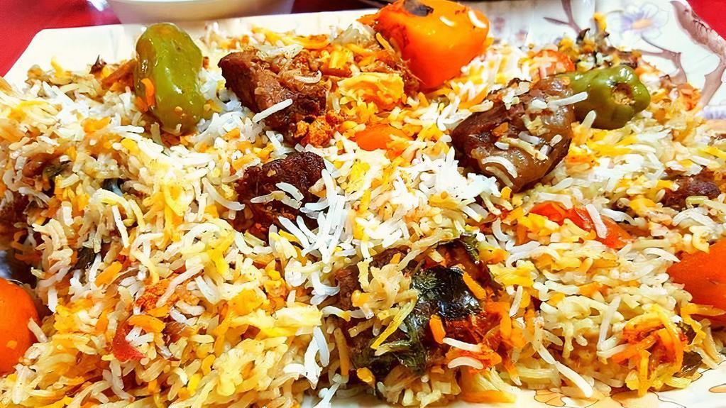 Beef Biryani · Flavorful rice cooked with cubes of beef marinated with Masala, saffron, and spices, served with raita on the side.