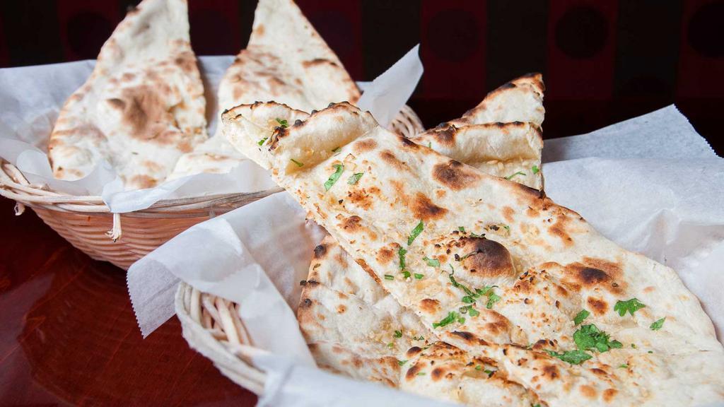 Naan · Leavened white bread baked in clay oven.