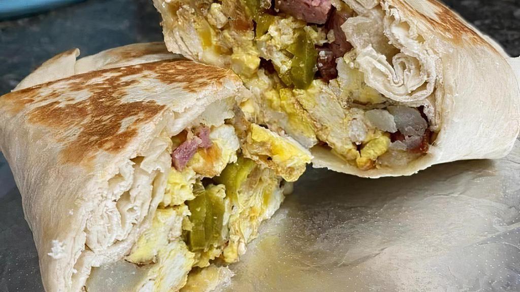 Small Breakfast Burrito · 2 scrambled eggs, meat of your choice, melted cheese wrapped in a flour tortilla. Picture is of a cheese crusted large burrito but the small burrito is same just smaller. Price may very depending on meat choice.
