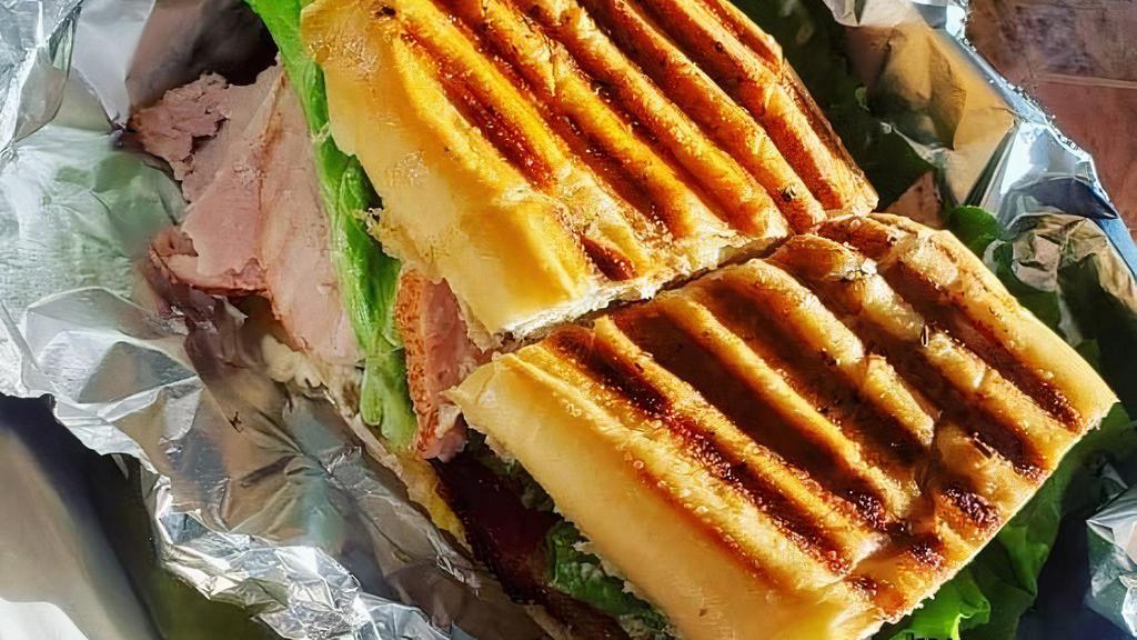 Panini · Slow roasted turkey & hickory smoked ham with provolone, crisp lettuce topped with homemade ranch and mayo on a perfectly seasoned garlic toasted French bread. The Panini is a toasted French bread sandwich, not a melt.