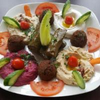 Vegetarian Sampler · Four falafel balls, four grape leaves, hummus, baba ganouj, tzatziki, and beets dip with pit...