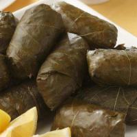 Stuffed Grape Leaves · Grapevine leaves stuffed with rice, parsley, onions, spices, and olive oil. Served with pita...