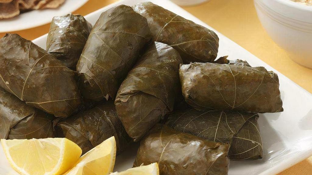 Stuffed Grape Leaves · Grapevine leaves stuffed with rice, parsley, onions, spices, and olive oil. Served with pita bread.