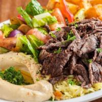Lamb Shawarma · Sliced marinated lamb, layered, and rotisserie roasted with grilled vegetables. Served with ...