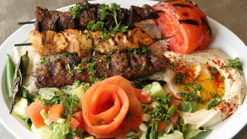 Mixed Kabob · Lamb chops, kofta kebab, and shish taouk with grilled vegetables. Served with pita, rice and side of tzatziki.