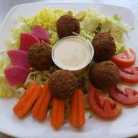 Falafel Salad · Vegetarian. Chopped lettuce, tomatoes, pickled, parsley, falafel balls and tahini sauce on t...
