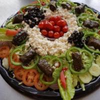Greek Salad · Garden salad with feta cheese and grape leaves. Vegetarian.