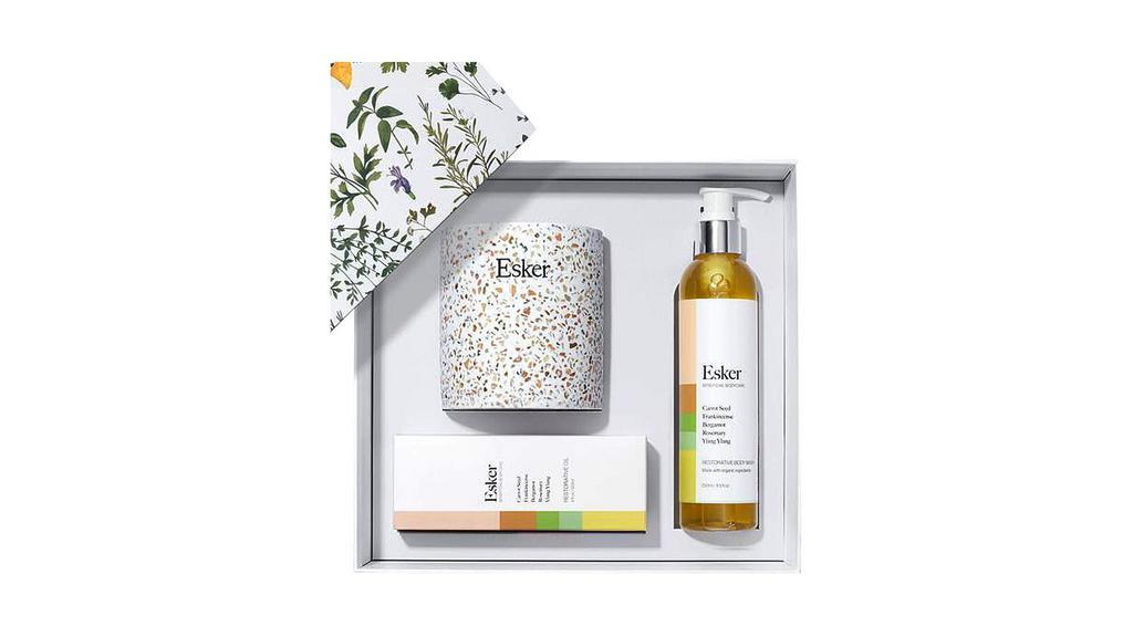 Restorative Gift Set · Esker. Gift set comprised of three steps that work in unison to provide intense moisture for skin in need. Housed in a simple natural linen bag, the Restorative set consists of a body oil, body wash, and a dry brush. While each step is effective and unique in its own way, when used together skin is left glowing and moisturized. Notes of wood, balsam and hints of smoke and florals offer a subtle aroma.

Comes in plastic-free recyclable gift box.
Includes: 4 oz body oil, 8.5 oz body wash, and a dry brush.
Made in USA.
