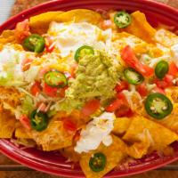 Nachos · Tortilla chips topped with melted cheese, lettuce, tomato, salsa, sour cream, and guacamole.