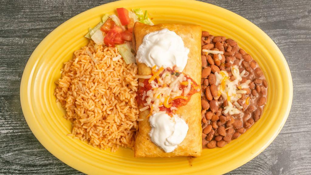 Chimichanga · Flour tortilla stuffed with chicken or beef, rice and beans, and deep fried, topped with sour cream and salsa.