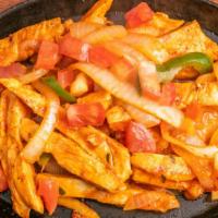 Fajitas De Pollo · Served on a hot sizzling skillet with peppers onions and tomatoes accompanied by a side of l...