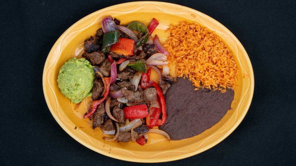 Steak Fajitas · Grilled marinated steak strips with peppers and onions, served with three flour tortillas and guacamole.