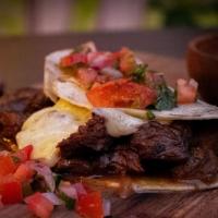 Tacos Rancheros · Flour tortillas stuffed with marinated sirloin steak tips in melted cheese, with pico de gal...