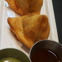 Vegetable Samosas (2) · Triangular Savory Pastry, Cumin, Green peas, Potatoes Served with Mint and Tamrind & Date Ch...